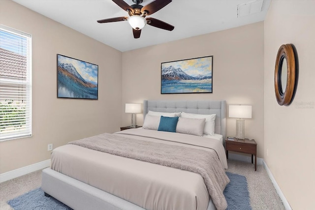 carpeted bedroom featuring multiple windows, visible vents, baseboards, and ceiling fan