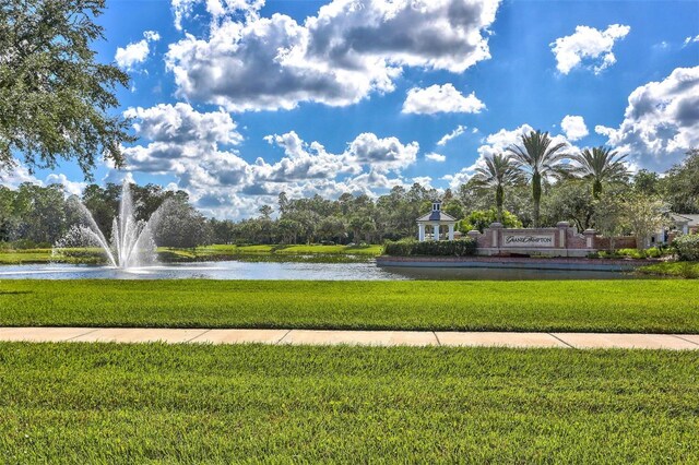 view of community with a water view and a yard