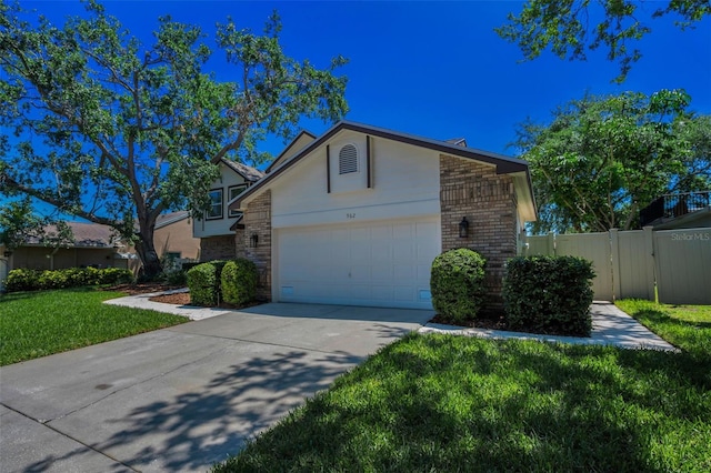 view of front of property featuring a gate, concrete driveway, brick siding, a garage, and a front yard