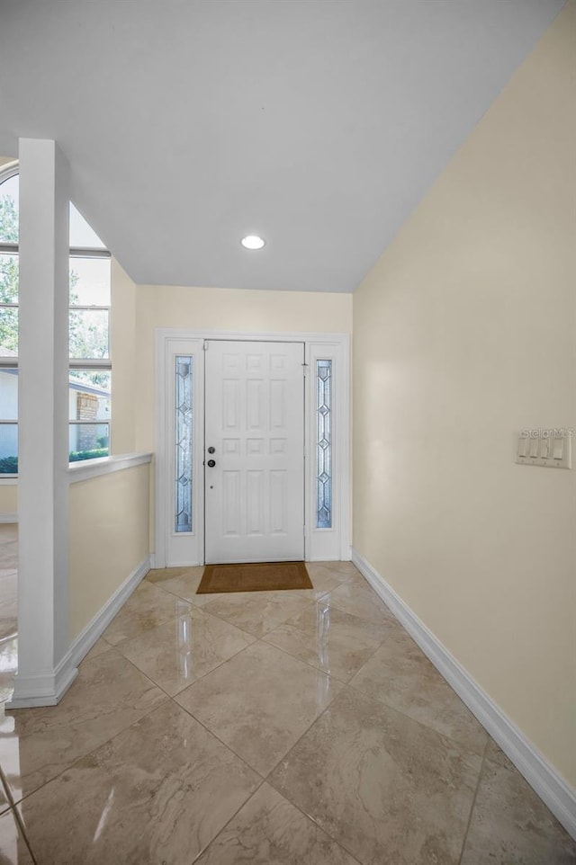 foyer featuring recessed lighting, marble finish floor, and baseboards