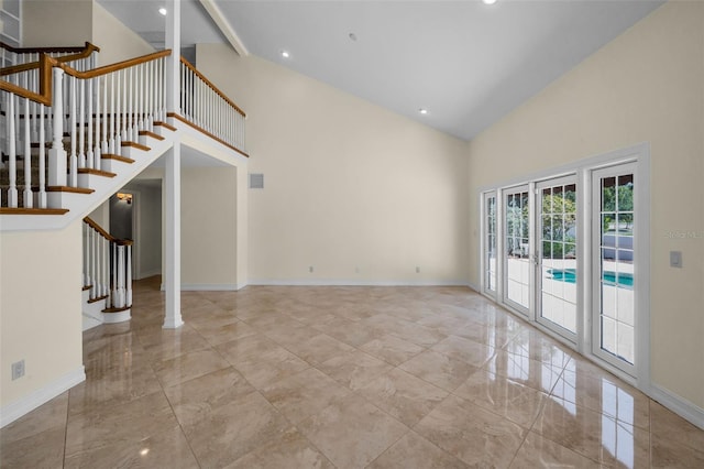 unfurnished living room featuring baseboards, stairs, marble finish floor, and high vaulted ceiling