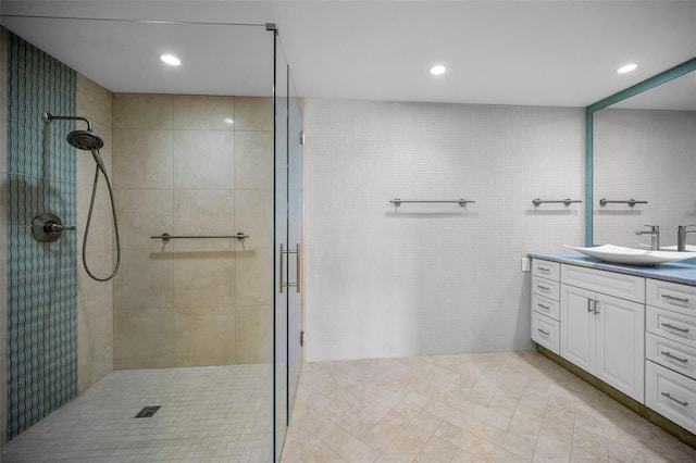 full bath with tile patterned flooring, vanity, recessed lighting, and tiled shower