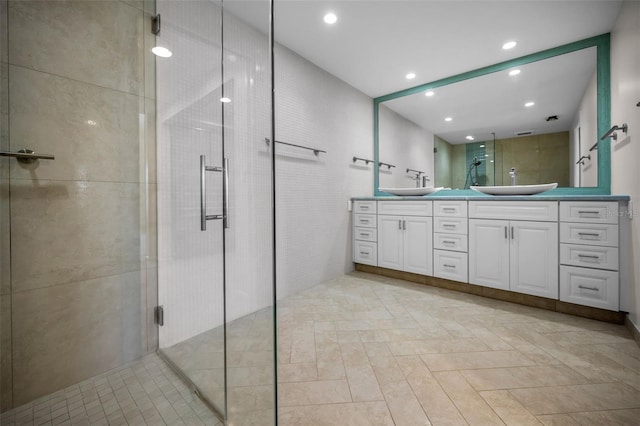 full bath with a sink, recessed lighting, double vanity, and a stall shower