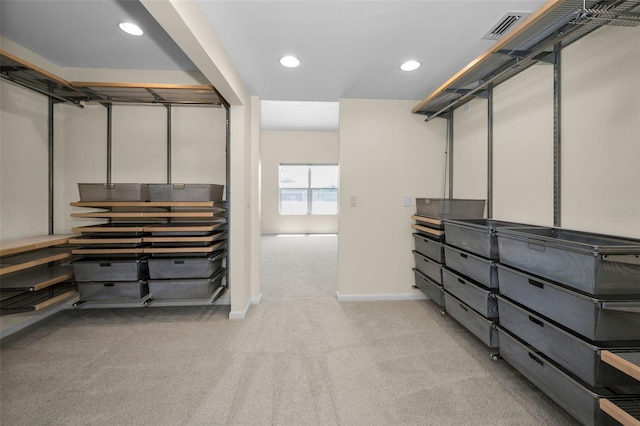 spacious closet with visible vents and light colored carpet