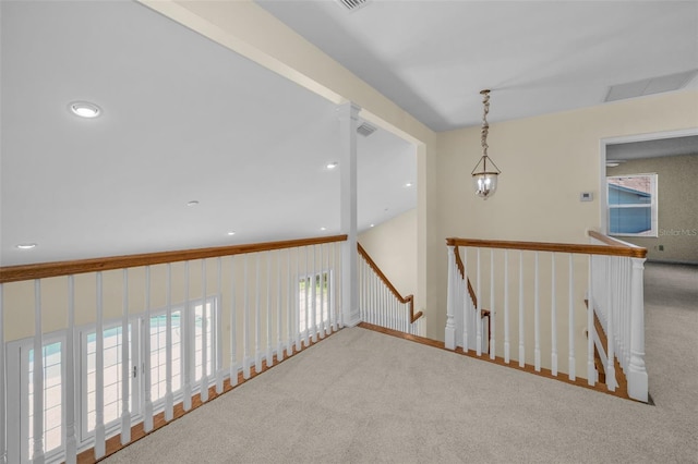 hall with recessed lighting, an upstairs landing, and carpet
