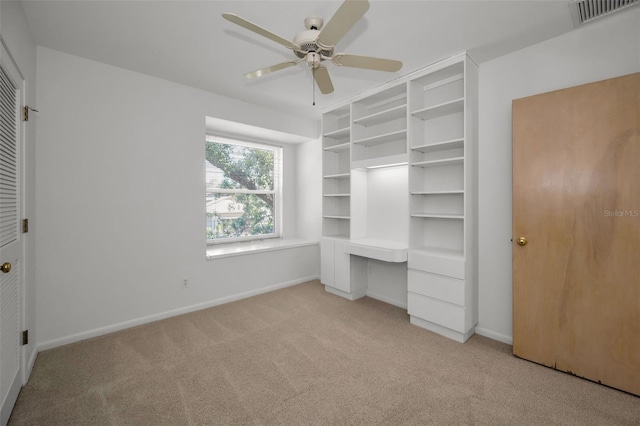 unfurnished bedroom featuring light carpet, a ceiling fan, visible vents, and baseboards