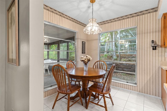 dining room with a healthy amount of sunlight, baseboards, wallpapered walls, and a chandelier
