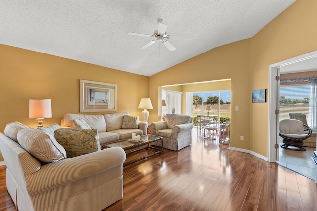 living area with wood finished floors, a ceiling fan, and plenty of natural light