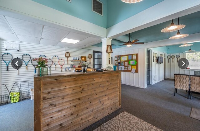 3119 Bent Creek Dr, Valrico, FL 33596 - kitchen with dark colored carpet and wood walls