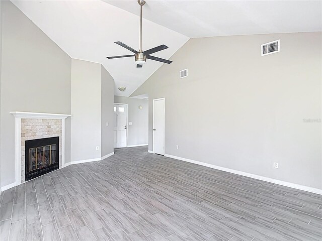 1530 High Knoll Dr, Brandon, FL 33511 - unfurnished living room with high vaulted ceiling, a ceiling fan, wood finished floors, and a fireplace