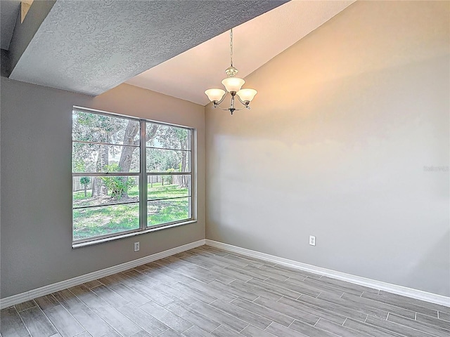 1530 High Knoll Dr, Brandon, FL 33511 - unfurnished room with a chandelier, light wood-style floors, and vaulted ceiling