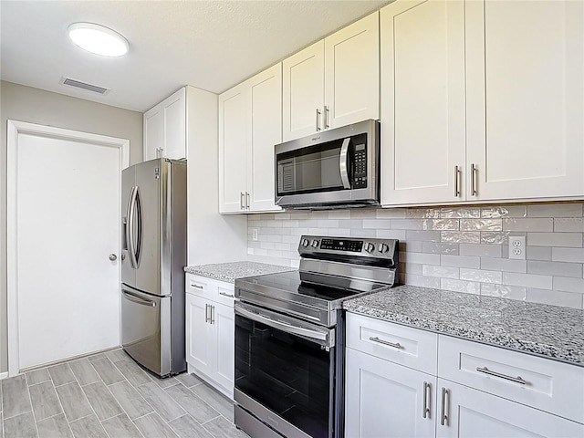 1530 High Knoll Dr, Brandon, FL 33511 - kitchen featuring stainless steel appliances, light stone counters, and backsplash