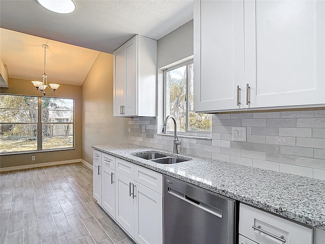 1530 High Knoll Dr, Brandon, FL 33511 - kitchen with dishwasher, a chandelier, vaulted ceiling, light stone counters, and white cabinetry