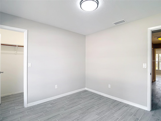 1530 High Knoll Dr, Brandon, FL 33511 - unfurnished bedroom featuring wood tiled floors, a closet, and a spacious closet