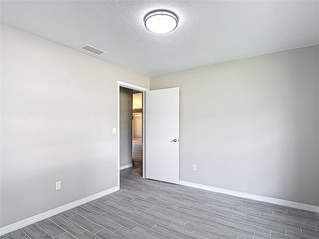 1530 High Knoll Dr, Brandon, FL 33511 - spare room featuring wood tiled floors and a textured ceiling
