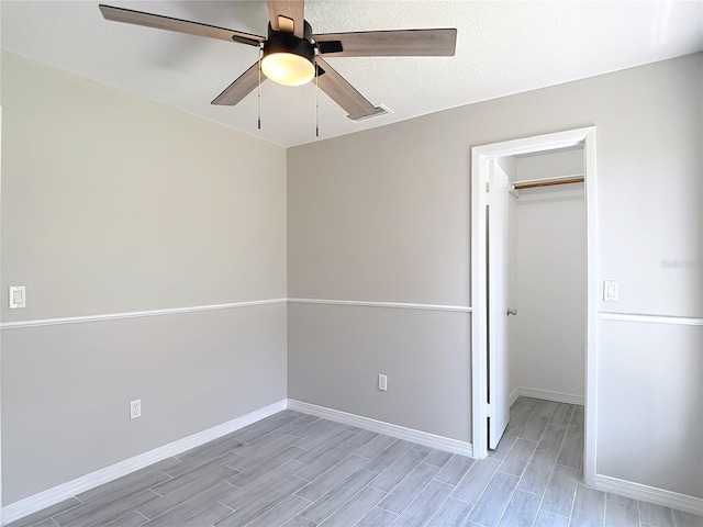1530 High Knoll Dr, Brandon, FL 33511 - unfurnished bedroom with a spacious closet, wood finish floors, a closet, and ceiling fan
