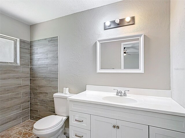 1530 High Knoll Dr, Brandon, FL 33511 - full bathroom featuring vanity, ceiling fan, a textured wall, and tiled shower