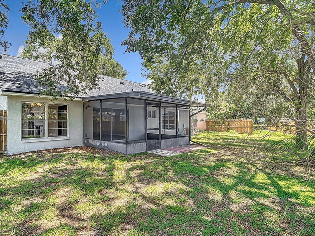 1530 High Knoll Dr, Brandon, FL 33511 - back of house featuring a sunroom, stucco siding, and a shingled roof