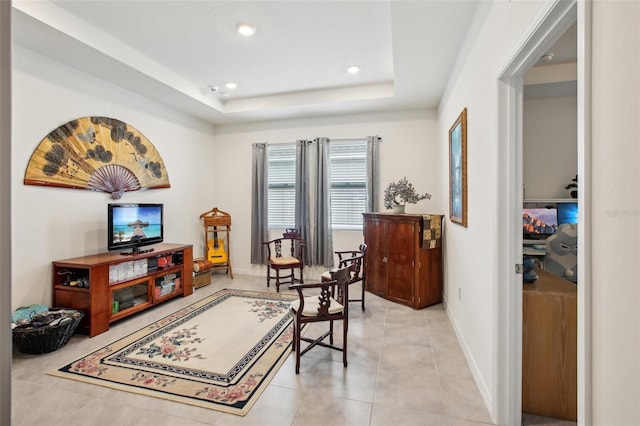 living area with light tile patterned floors, baseboards, a tray ceiling, and recessed lighting