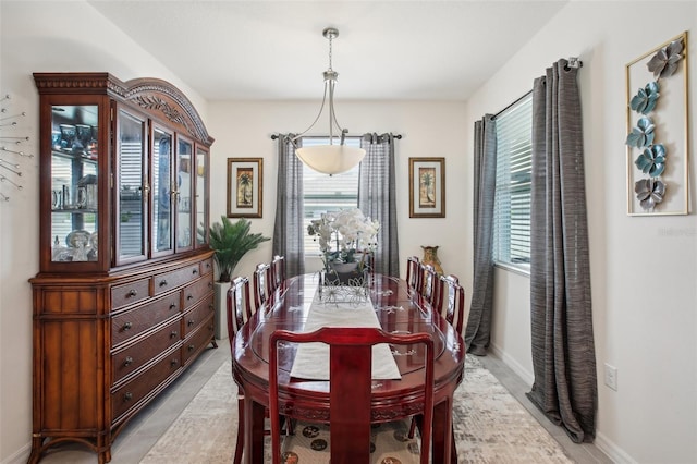 dining room featuring a wealth of natural light, baseboards, and light tile patterned floors