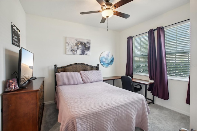 carpeted bedroom featuring a ceiling fan and baseboards