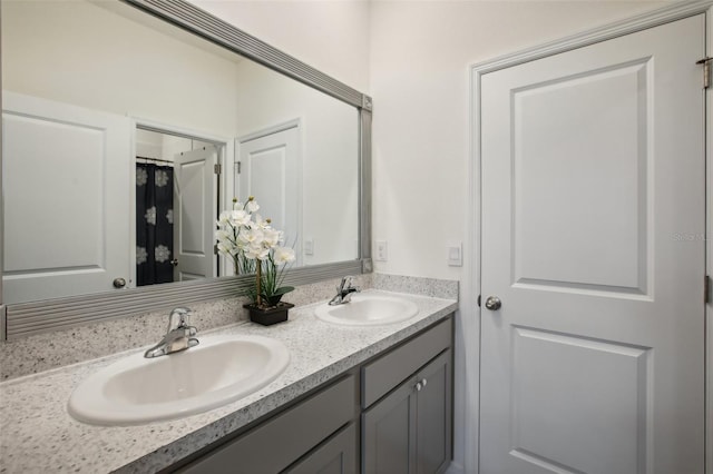 full bath featuring a sink and double vanity