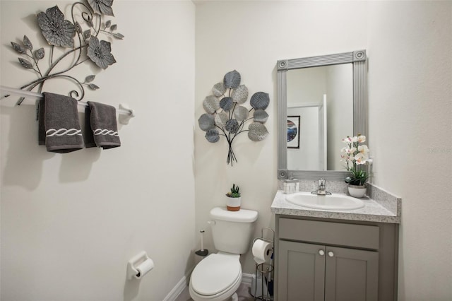 bathroom featuring toilet and vanity