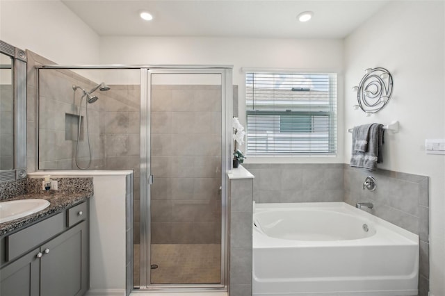 full bath with a shower stall, a garden tub, and vanity