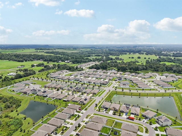 drone / aerial view featuring a residential view and a water view