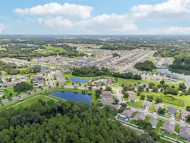 drone / aerial view featuring a residential view and a water view