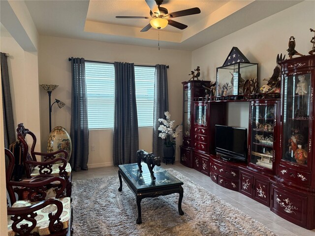 7323 Steer Blade Dr, Zephyrhills, FL 33541 - living room featuring ceiling fan, tile patterned floors, and a raised ceiling