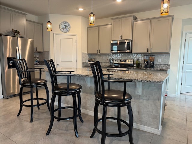 7323 Steer Blade Dr, Zephyrhills, FL 33541 - kitchen featuring stainless steel appliances, gray cabinets, stone countertops, backsplash, and hanging light fixtures