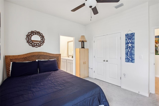7323 Steer Blade Dr, Zephyrhills, FL 33541 - bedroom with light colored carpet, a closet, ceiling fan, baseboards, and ensuite bathroom