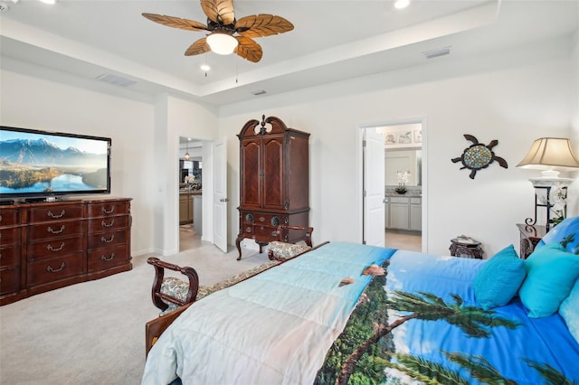 7323 Steer Blade Dr, Zephyrhills, FL 33541 - bedroom featuring a tray ceiling, recessed lighting, light carpet, ensuite bathroom, and a ceiling fan