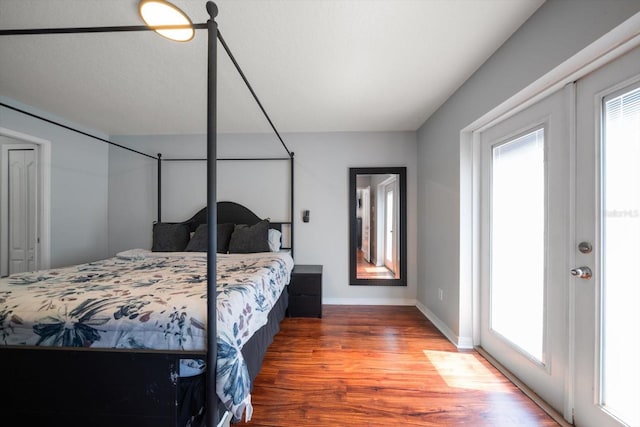 bedroom featuring baseboards and wood finished floors