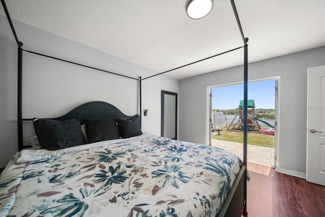 bedroom with baseboards, wood finished floors, access to exterior, and a textured ceiling