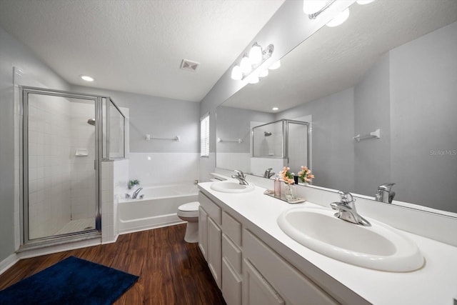 full bathroom with a bath, a sink, visible vents, and a stall shower