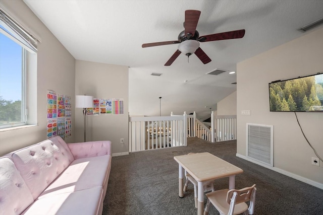 carpeted living room featuring visible vents, a ceiling fan, and baseboards