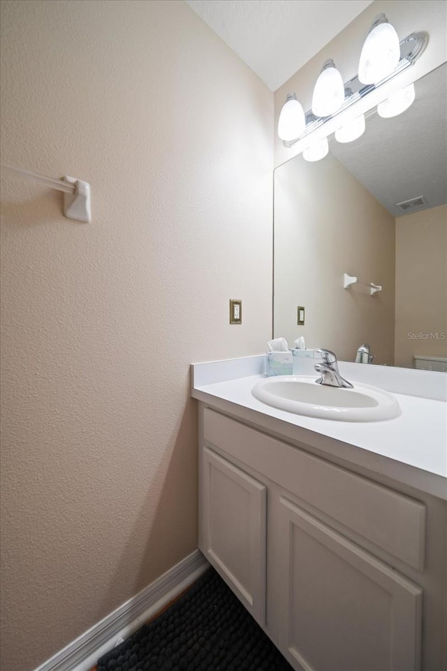 bathroom with visible vents and vanity