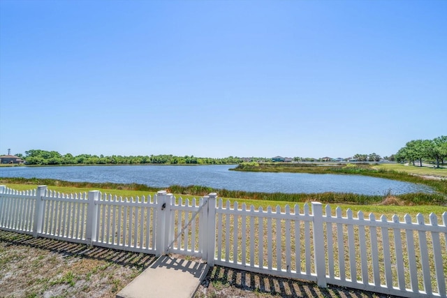 property view of water featuring fence