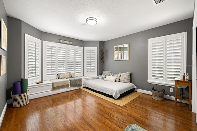 5902 Audubon Manor Blvd, Lithia, FL 33547 - bedroom with multiple windows, wood finished floors, and baseboards