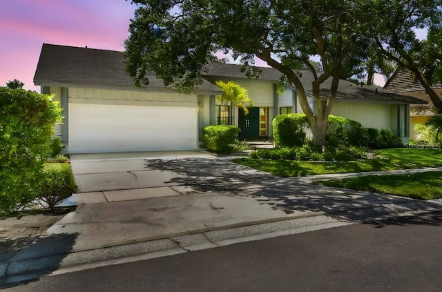 4226 Saltwater Blvd, Tampa, FL 33615 - obstructed view of property featuring concrete driveway and an attached garage