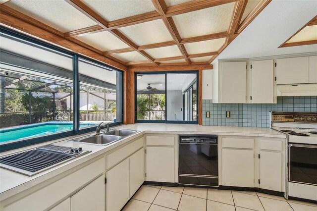 4226 Saltwater Blvd, Tampa, FL 33615 - kitchen with decorative backsplash, white range with electric cooktop, black dishwasher, under cabinet range hood, and coffered ceiling