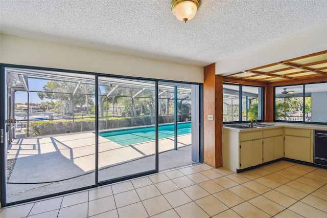 4226 Saltwater Blvd, Tampa, FL 33615 - interior space featuring a textured ceiling, a sink, cream cabinetry, and dishwasher