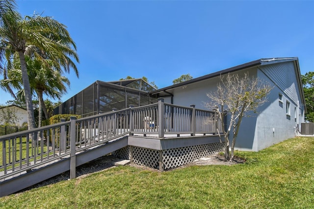 4226 Saltwater Blvd, Tampa, FL 33615 - back of property featuring central air condition unit, a yard, a wooden deck, and stucco siding