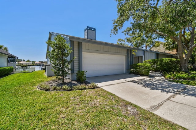 4226 Saltwater Blvd, Tampa, FL 33615 - view of side of property with fence, a garage, a chimney, a yard, and driveway