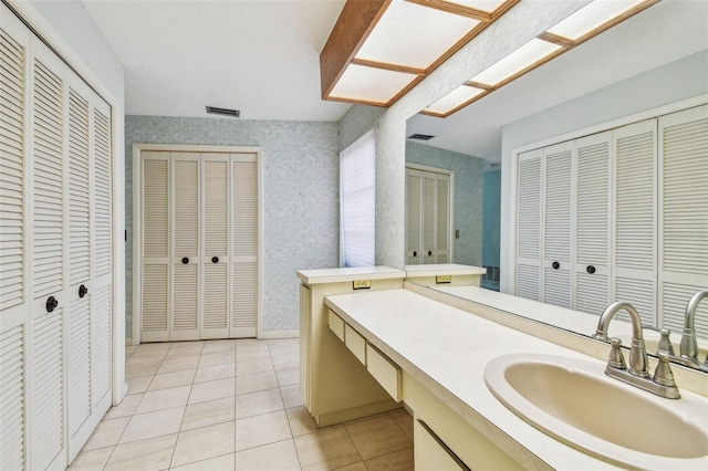 4226 Saltwater Blvd, Tampa, FL 33615 - bathroom featuring vanity, tile patterned floors, a closet, and wallpapered walls