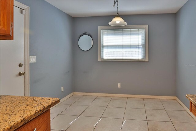 1915 Peppertree Dr, Oldsmar, FL 34677 - unfurnished dining area featuring baseboards and light tile patterned floors