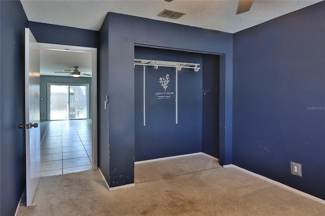 1915 Peppertree Dr, Oldsmar, FL 34677 - interior space with a textured ceiling, carpet floors, a closet, baseboards, and a ceiling fan