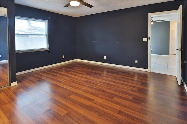 1915 Peppertree Dr, Oldsmar, FL 34677 - spare room featuring a ceiling fan, wood finished floors, a textured ceiling, and baseboards